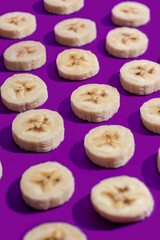 Banana slices on a purple surface