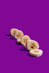Banana slices on a purple surface