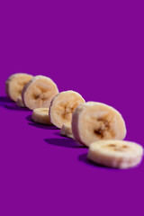 Banana slices on a purple surface