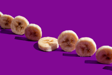 Banana slices on a purple surface