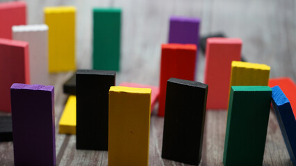 colorful bricks on white backgrounds in different positions and shapes making buildings