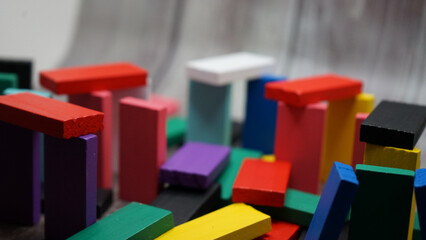 colorful bricks on white backgrounds in different positions and shapes making buildings