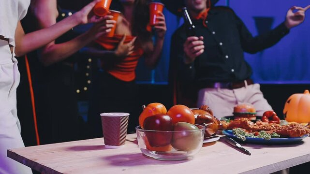 Four people dancing at a costume Halloween party in a house.