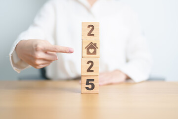 Happy New Year 2025 with Home and Heart block. Property investment, House Mortgage, Real Estate tax, homeless, donation, Financial and happy family concepts
