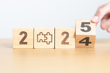2024 year change to 2025 year block with jigsaw puzzle icon. Business Process, Team, teamwork, Goal, mission, Resolution, strategy, plan, Action, partnership, and New Year start