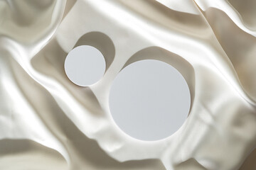 Modern Minimalist White Sculpture Displayed on Soft Draped Fabric in Natural Light
