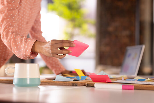At office, Organizing sticky notes, woman brainstorming ideas for creative writing business