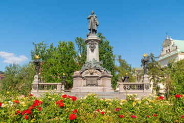 Adam Mickiewicz Monument in summer among flowers. August 9, 2024. Warsaw, Poland.