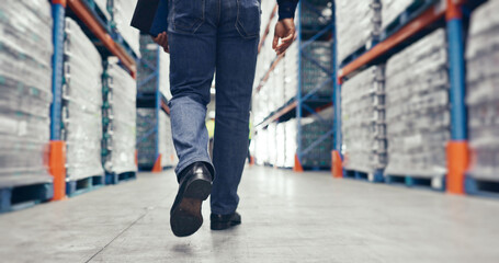Fototapeta premium Walking, warehouse and legs of logistics worker with quality assurance, stock control or inspection duty. Ecommerce, industry and distribution manager in supply chain factory for export or delivery.