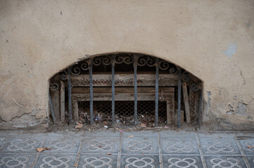 Detail of a kind of small window at ground level in a building in Barcelona, ​​it looks like a basement vent