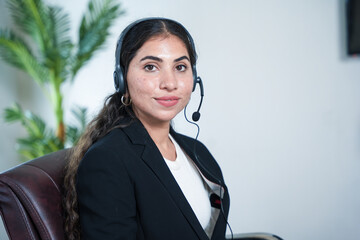 Happy indian service support operator or agent woman wearing headset looking at camera. call center...