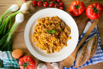 Rice paella with pork loin and green beans. Top view table.