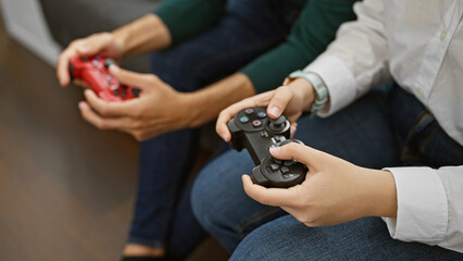 Couple gaming together comfortably in a cozy home living room, enjoying their leisure time indoors.