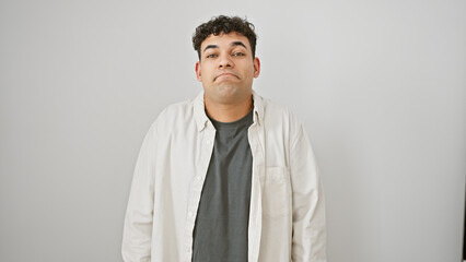 Handsome young adult man with beard in casual outfit standing against a white isolated background