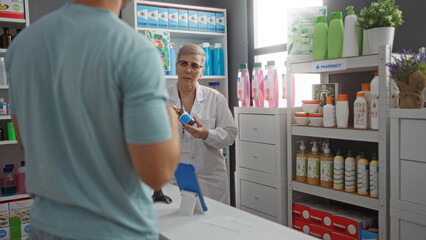 Woman pharmacist assists man customer in a brightly lit pharmacy interior surrounded by various...