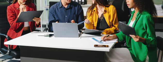 Obraz premium Multiracial group of young creative people in smart casual wear discussing business brainstorming meeting ideas design project.