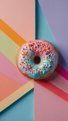 A colorful donut with colorful rainbow sprinkles on top on a colorful table