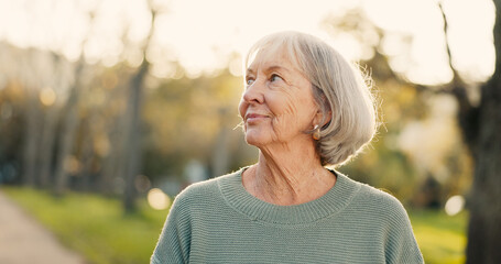 Walking, thinking and mature woman in park for wellness, health and relax with reflection,...