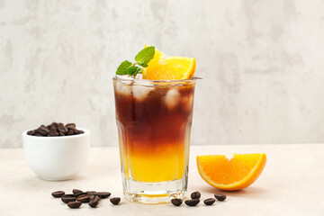 Iced americano black coffee and layer of orange juice  
