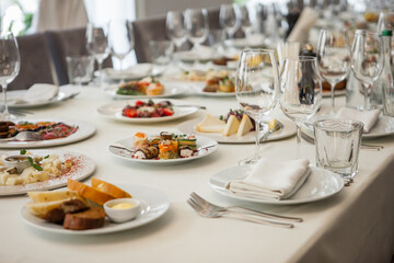 served table, glasses, plates, vase with forge