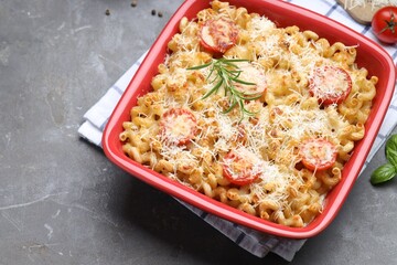 Delicious al forno pasta in baking dish on grey table, closeup