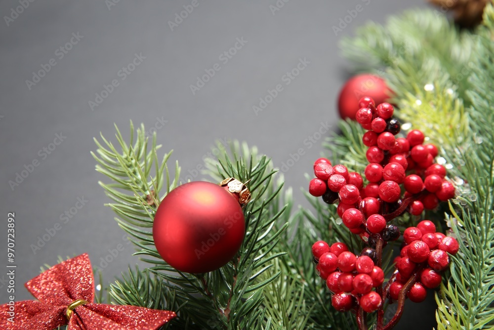 Wall mural fir tree branches with christmas decor on grey background, closeup. space for text