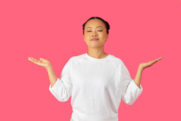 Asian woman in a white sweater smiles and holds her arms out, exuding a sense of calm and serenity...