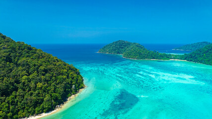 Fototapeta premium The aerial view of white sand beach tropical with seashore as the island in a coral reef ,blue and turquoise sea Amazing nature landscape with blue lagoon