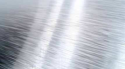 A tight focus on an intricately grained metal surface, brushed texture, fine linear patterns, industrial and sleek