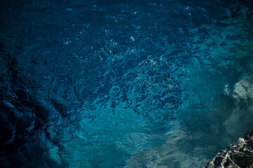 Beautiful turquoise blue water bubbling in a small whirlpool