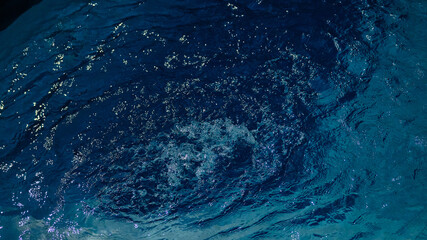 Beautiful turquoise blue water bubbling in a small whirlpool