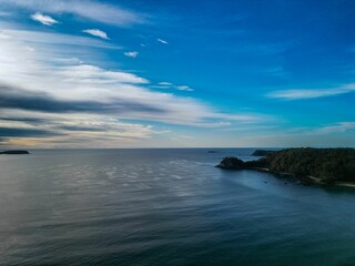 Serene coastal landscape with blue skies and calm waters