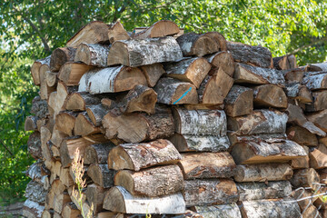 Firewood background, chopped wood texture, stacked wood preparing fuel for heating in winter