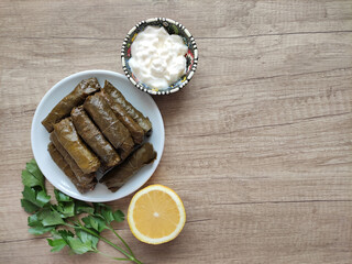 Traditional oriental Turkish dolma made of grape leaves stuffed with rice on a decorative plate