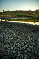Half-dried lake b legacy of global warming summer b hot days in the summer dried up the lake. Cracked earth around the lake. The water level in the lake dropped to impressive proportions