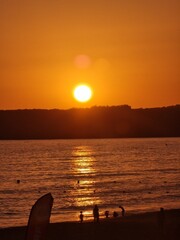 A stunning sunset over the ocean in Tarifa, Spain, with the golden light reflecting off the water...
