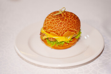 Mini burger with patty, cheese, tomato and lettuce. 
