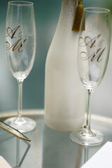 A bottle of wine and glasses with the abbreviation of the names of the newlyweds. Wedding ceremony.