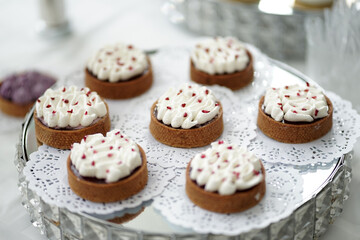 Cookies with cream on a glass stand.