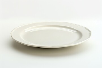 A white plate sitting on a table, perfect for food photography or as a prop