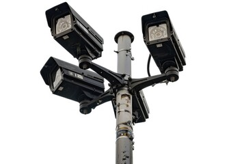 A street light with three security cameras attached, providing surveillance and monitoring capabilities