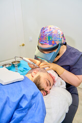 Surgeon performing hair transplant with precision tool