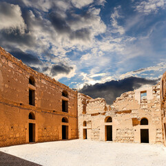 Qasr Kharana (Kharanah or Harrana)-- desert castle in eastern Jordan (100 km of Amman). Built in 8th century AD to be used as caravanserai, a resting place for traders. Against the sky with clouds