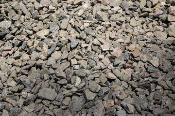 A close-up photograph of a pile of gray crushed stone gravel