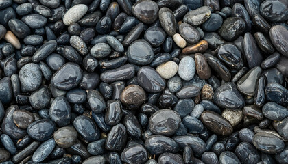 Smooth wet pebbles, texture background. Sea or ocean shore beach. Top view.