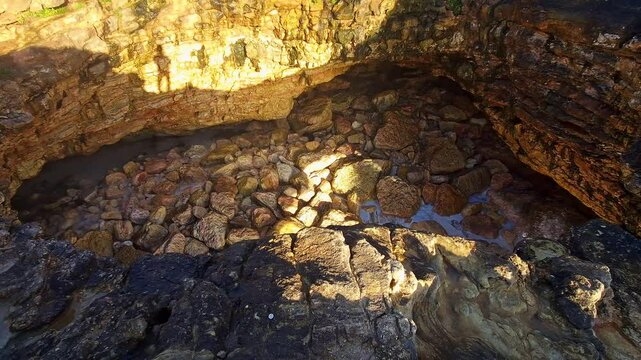Looking through the top of the Forno de Orca Cave, Gruta Forno de Orca on the North Beach, Praia do Norte of Nazare, Portugal