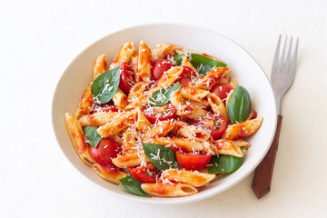 Pasta penne alla arrabiata with tomatoes, basil and parmesan cheese. Healthy Eating. Vegetarian Food.
