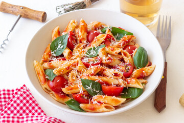 Pasta penne alla arrabiata with tomatoes, basil and parmesan cheese. Healthy Eating. Vegetarian Food.
