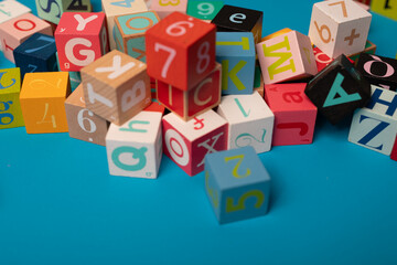 Colorful alphabet blocks scattered on a blue background Learning the ABCs