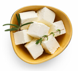 Feta cheese cubes and oregano in ceramic bowl on white background, top view